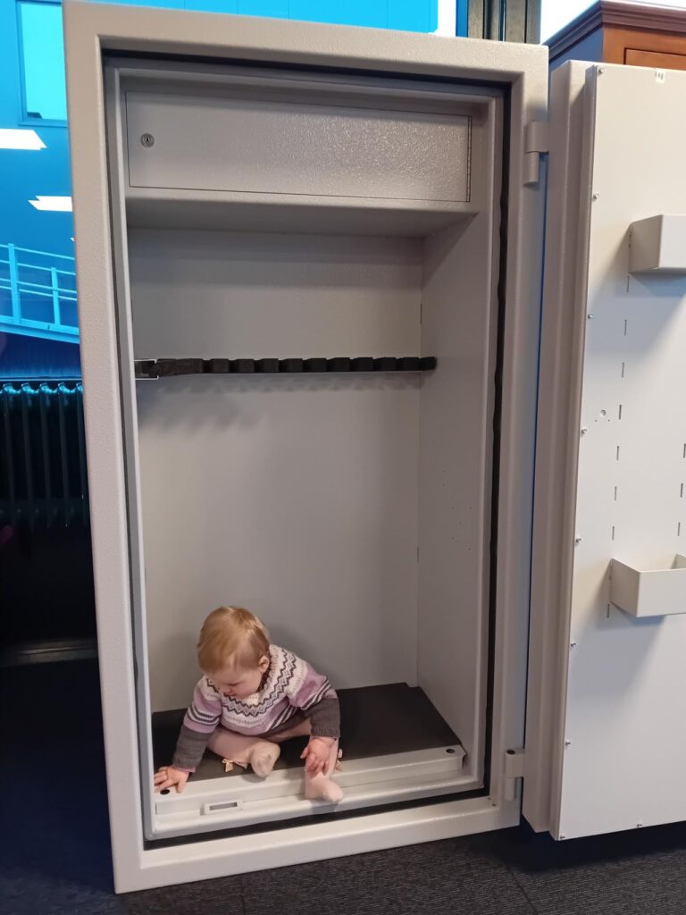 a baby sitting in a safe